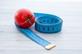 Measuring tape and juicy tomato, the concept of healthy nutrition and weight loss Royalty Free Stock Photo