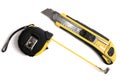 Measuring tape and paper knife. Royalty Free Stock Photo