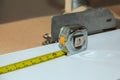 Measuring tape on work surface with ruler laid out for project in workshop setting Royalty Free Stock Photo