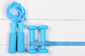 Measuring tape and sports equipment. Barbells, centimeter and jump rope Royalty Free Stock Photo