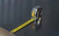 Measuring tape on a steel plate. Royalty Free Stock Photo