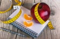 Measuring tape wrapped around a apple weight loss Royalty Free Stock Photo