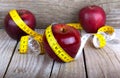 Measuring tape wrapped around a apple weight loss Royalty Free Stock Photo