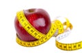 Measuring tape wrapped around a apple weight loss Royalty Free Stock Photo