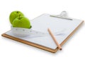 Measuring tape wrapped around a green apple and clipboard Royalty Free Stock Photo