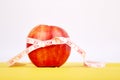 Measuring tape wrapped around a red apple Royalty Free Stock Photo