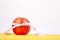 Measuring tape wrapped around a red apple Royalty Free Stock Photo