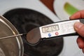 Measuring the Temperature of Sugar Boiling or Caramel Syrop through the various candy stages. Royalty Free Stock Photo
