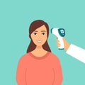 Measuring the temperature of a woman with medical digital infrared thermometer in front view. Covid-19 coronavirus epidemic outbre Royalty Free Stock Photo