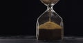 Measuring time with Hourglass and sand Royalty Free Stock Photo