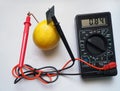 Measuring voltage from lemon battery Royalty Free Stock Photo
