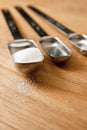 Measurings Spoons on Wood Counter with Sugar Royalty Free Stock Photo