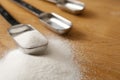 Measurings Spoons on Wood Counter with Sugar Royalty Free Stock Photo
