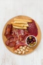 Meat appetizer with olives and nuts on tray Royalty Free Stock Photo