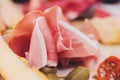 Meat appetizer selection. Salami, prosciutto, bread sticks, baguette, olives and sun-dried tomatoes, selective focus. Royalty Free Stock Photo