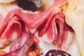 Meat appetizer selection. Salami, prosciutto, bread sticks, baguette, olives and sun-dried tomatoes, selective focus. Royalty Free Stock Photo