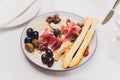 Meat appetizer selection. Salami, prosciutto, bread sticks, baguette, olives and sun-dried tomatoes, selective focus. Royalty Free Stock Photo