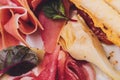 Meat appetizer selection. Salami, prosciutto, bread sticks, baguette, olives and sun-dried tomatoes, selective focus. Royalty Free Stock Photo