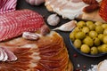 Meat appetizers - jamon, ham, chorizo, bacon with fresh olives and tomatoes.