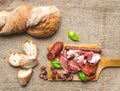 Meat appetizers selection and a loaf of rustic village bread on Royalty Free Stock Photo