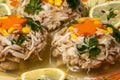 Meat aspic decorated with pomegranate, green peas, carrot and parsley. Restaurant dish for a celebratory feast selective focus Royalty Free Stock Photo