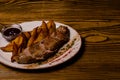 Meat balls with potatoes in a baking dish and sour cream close-up on a table. horizontal view from above Royalty Free Stock Photo