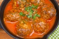 Meat balls in spicy tomato sauce with herbs in a iron pan. Close up. Top view Royalty Free Stock Photo