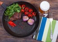 Meat, beer and vegetables in frying pan Royalty Free Stock Photo
