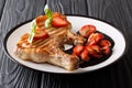 Meat and berries: grilled pork chop with basil and balsamic strawberry sauce close-up on a plate. horizontal Royalty Free Stock Photo