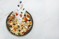 meat black dough Pizza with vegetables on white marble background with ingredients. Flying food concept. Royalty Free Stock Photo