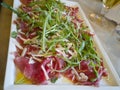 Meat Carpaccio with Rocket Salad and Cheese Flakes