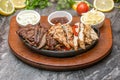 Meat and chicken fajitas on black stone plate with sauces Royalty Free Stock Photo