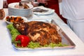 The meat is cooked in the oven. A big piece of meat. Chef cuts the finished meat in the kitchen. Meat with vegetables. Royalty Free Stock Photo