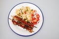 Meat and Cooked white rice mixed with colorful vegetables onion, green beans, tomato Royalty Free Stock Photo