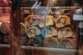 Meat on the counter of an Italian store behind glass