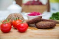 Meat cutlets, baked buckwheat on a wooden board . Red cabbage sauerkraut . Garlic, Onion, Tomatoes. Chopped coriander. Homemade