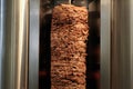 A stick of Arab shwarma in front of the grill