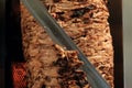 A stick of Arab shwarma in front of the grill