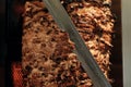 A stick of Arab shwarma in front of the grill