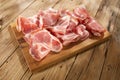 meat delicacy in cutting on a wooden surface close-up. dry-cured pork on a tray. traditional snack in rustic style.