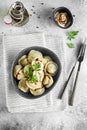 Meat dumplings - russian pelmeni, ravioli with meat on a grey bowl. Flat lay composition Royalty Free Stock Photo