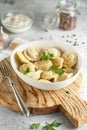 Meat dumplings - russian pelmeni, ravioli with meat on a white plate on a wooden board Royalty Free Stock Photo