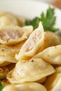 Meat dumplings - russian pelmeni, ravioli with meat on a white plate on a wooden board Royalty Free Stock Photo