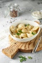 Meat dumplings - russian pelmeni, ravioli with meat on a white plate on a wooden board Royalty Free Stock Photo