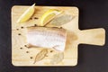 Meat fish, pepper peas, bay leaf and lemon closeup. Ingredients for dish from seafood. Top view Royalty Free Stock Photo