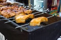 Meat and fish on skewers preparing on open grill by chef during bbq festival. Selective focus. Russia, Moscow, 26-28th July 2019, Royalty Free Stock Photo