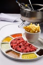 Meat fondue with different sauces and french fries