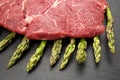 Meat food : raw beef fillet on black stone board with asparagus