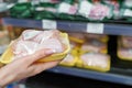 Meat in food store . Woman choosing packed fresh chicken meat in supermarket Royalty Free Stock Photo