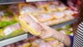 Meat in food store . Woman choosing packed fresh chicken meat in supermarket Royalty Free Stock Photo